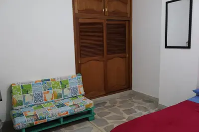 a room with a couch and a wooden door at Living Poblado Manila 3028 Habitación Doble in Medellín