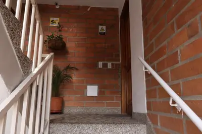 a staircase with a brick wall and a potted plant at Living Poblado Manila 3026 Habitación Individual in Medellín