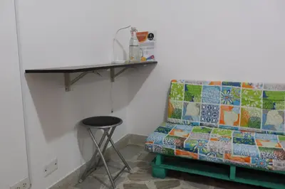 a couch in a room with a table and a stool at Living Poblado Manila 3027 Habitación Individual in Medellín