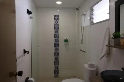 a bathroom with a shower with a toilet and a sink at Living Poblado Manila 301 G Hab Doble con Baño in Medellín