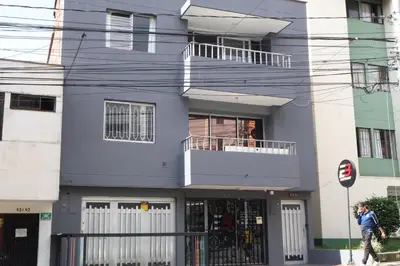 a man walking in front of a building at Living Poblado Manila 301 G Hab Doble con Baño in Medellín