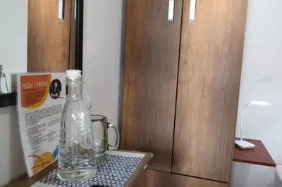 a bottle of water sitting on a table next to a door at Living Poblado Manila 301 B Habitación Individual in Medellín