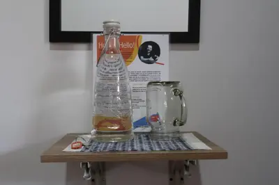 a bottle of water sitting on a shelf next to a blender at Living Poblado Manila 301 C Habitación Individual in Medellín