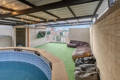 a large room with a swimming pool in a building at Apartamento en Laureles, con piscina y parquedero 401 in Medellín