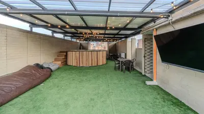 a conference room with a large screen and green carpet at Apartamento en laureles con piscina, parqueadero 302 in Medellín