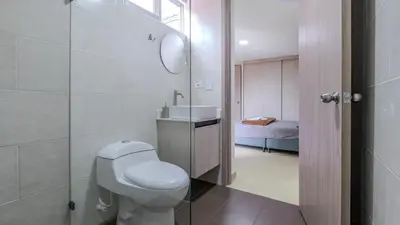 a bathroom with a toilet and a sink at Apartamento 2BR Parqueadero y Piscina 202 in Medellín