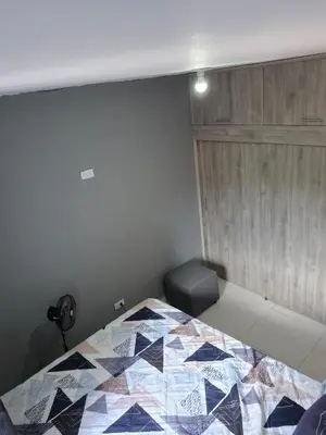 a bedroom with a bed with a quilt on it at Apartamento Super Exclusivo in Medellín