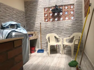 a room with two chairs and a table and a brick wall at habitacion amoblada in Sonsón