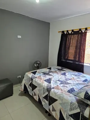 a bedroom with a bed with a quilt on it at GIGANTE y ELEGANTE APARTAMENTO UNIFAMILIAR in Belén