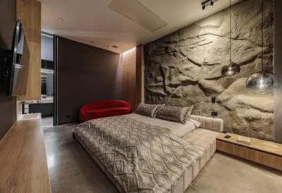 a bedroom with a bed and a stone wall at Luxurious Farm House in Rionegro