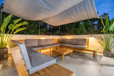 a patio with a couch and a table at Private Sauna Jacuzzi Billiard Gym Luxury Retreat in El Poblado