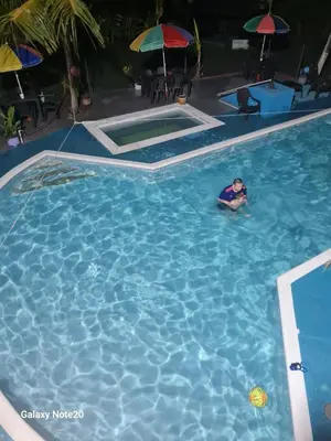 a person swimming in a large swimming pool at Siboney hotel in Honda