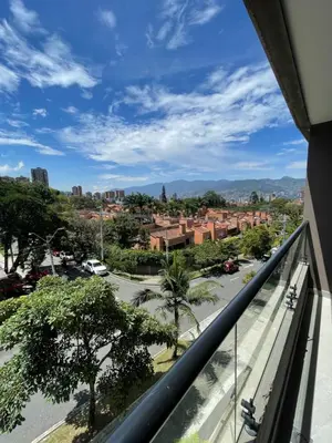 a view of a city from a balcony at Apartamento con vista y aire acondicionado cerca a El Tesoro in Medellín