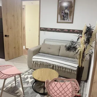a living room with a couch and a table and chairs at Diamante 204 in Guatapé
