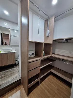a bathroom with wooden cabinets and a sink and a mirror at Apartamento Laureles con Jacuzzi cerca al primer parque in Medellín