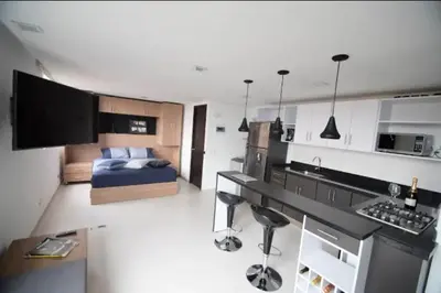 a kitchen and living room with a bed in a room at Espacio Ideal para Disfrutar Medellin in Medellín