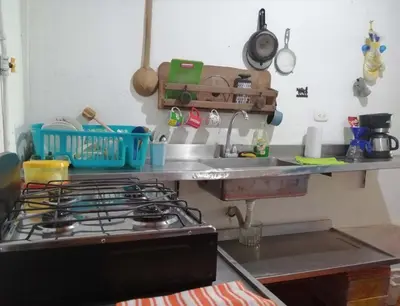 a kitchen counter with a stove and a sink at Casa del Rio Low cost in Honda