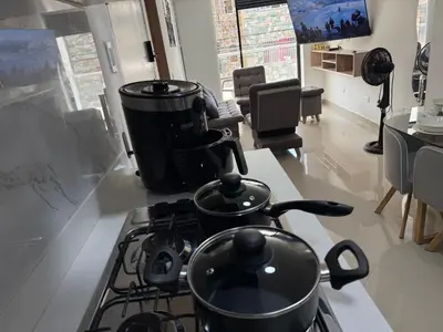 a kitchen with a stove with pots and pans on it at Vive Medellin 401 in Medellín