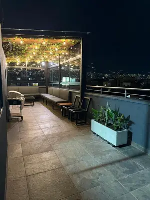 a balcony with a view of a city at night at Vive Medellin 401 in Medellín