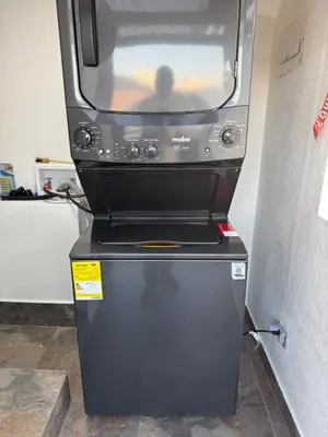 a microwave oven sitting on top of a refrigerator at Vive Medellin 302 in Medellín