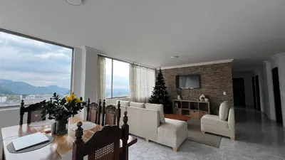 a living room with a table and chairs at Apartamento Vista Panoramica 3 habitaciones 2 baños - Av Santander Sector El Cable y Estadio Palogrande in Manizales