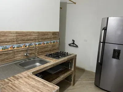 a kitchen with a sink and a stainless steel refrigerator at Apartamento Napoles in Doradal