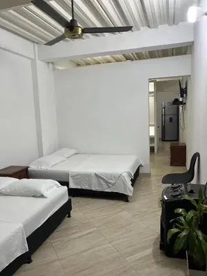 a bedroom with two beds and a ceiling fan at Apartamento Napoles in Doradal