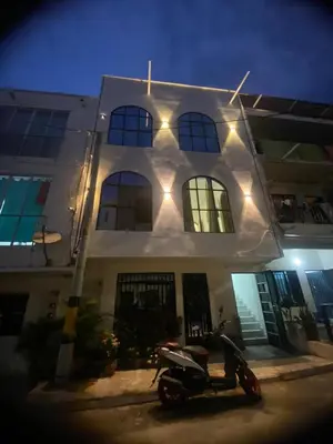 a scooter parked in front of a building with lights at Habitaciones en Doradal 205 in Doradal