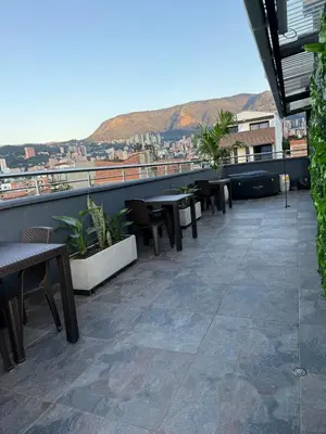a balcony with tables and chairs on a building at 201New apartment perfect location Close to poblado in Medellín