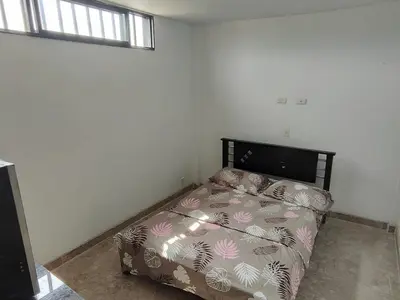 a bedroom with a bed in the corner of a room at Augusto Hernandez in Santa Fe de Antioquia