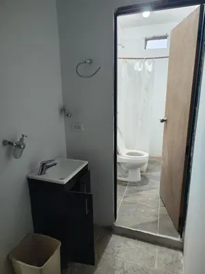 a bathroom with a toilet and a sink and a mirror at Augusto Hernandez in Santa Fe de Antioquia