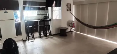 a kitchen with a hammock in the middle of a room at Apartasol Familiar 2 in Santa Fe de Antioquia