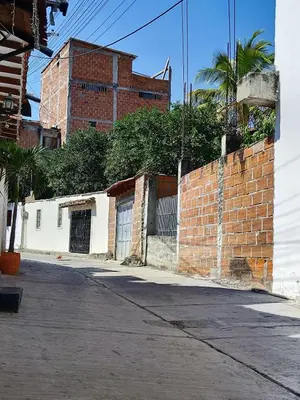 an empty street with a brick wall and a building at Spacious and calm place to stay in Santa Fe de Antioquia