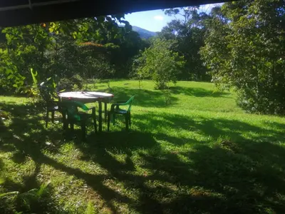 a table and chairs in a field of grass at Glasshouse with river in San Rafael