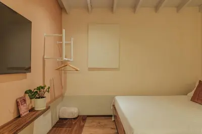 a bedroom with a bed and a plant on the wall at New designed Loft in Laureles with AC and WiFi in Medellín