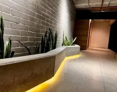 a hallway with plants and a brick wall at Loft hermoso y céntrico 1109 in Medellín