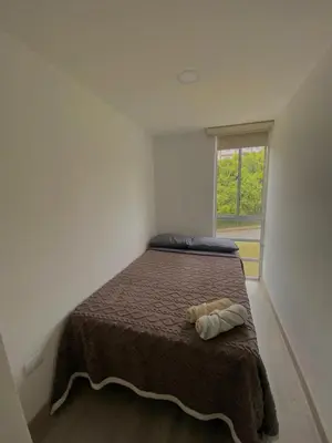 a bedroom with a large bed with a window at Apartamento Urban Manizales in Manizales