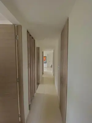 a hallway with wooden doors and a long corridor at Apartamento Urban Manizales in Manizales