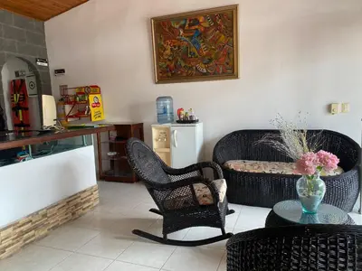 a living room with two chairs and a table at hotel kerana moon in Puerto Boyacá