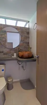 a bathroom with a sink and a toilet and a mirror at habitación campestre para pareja LAVANDA in Jardin