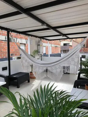 a hammock on the patio of a building at Aparta estudio 204 - Casa Bendita in Medellín