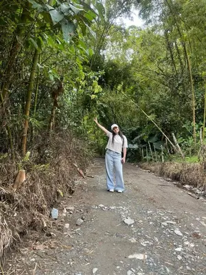 a man walking down a dirt road with his arm in the air at Coffee Tour, Colombia Aranzazu Caldas- Andean Motmot coffee in Aranzazu