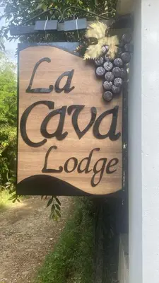 a sign on the side of a building that readscial local lodge at Cabernet Cabaña - La Cava Lodge in Medellín
