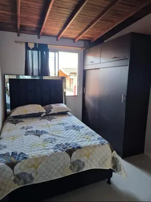 a bedroom with a bed and a large window at Apartamento Super Lindo in Medellín