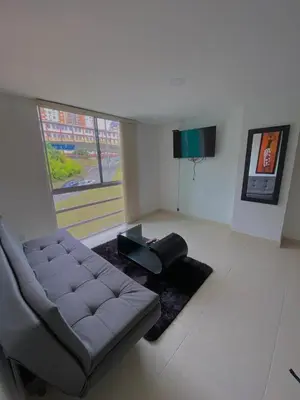 a living room with a couch and a table at Apartamento en Manizales in Manizales