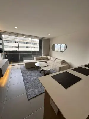 a living room with a couch and a table at Luxurious and Modern Apartment in Medellín