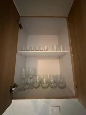 a cabinet filled with empty glasses on shelves at Luxurious and Modern Apartment in Medellín
