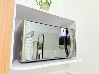 a microwave oven on a shelf in a room at Aparta estudio 103 - Casa bendita in Medellín