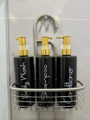 two black injector bottles on a rack in a bathroom at Aparta estudio 103 - Casa bendita in Medellín