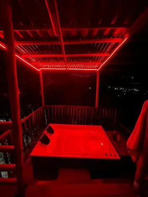 a red room with a bed with a red light at Titiribi-Antioquia- Cabaña el sol in Titiribí